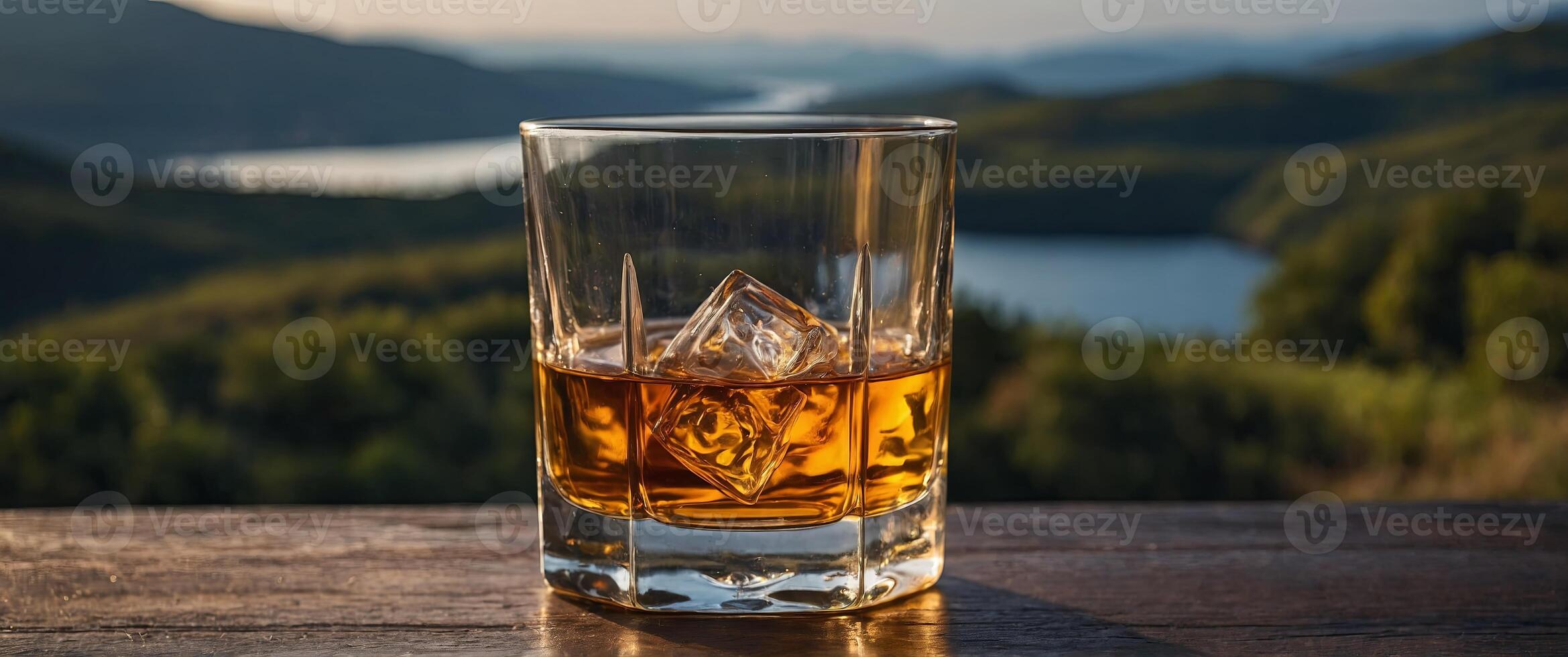 A glass of premium whiskey with a scenic view. photo