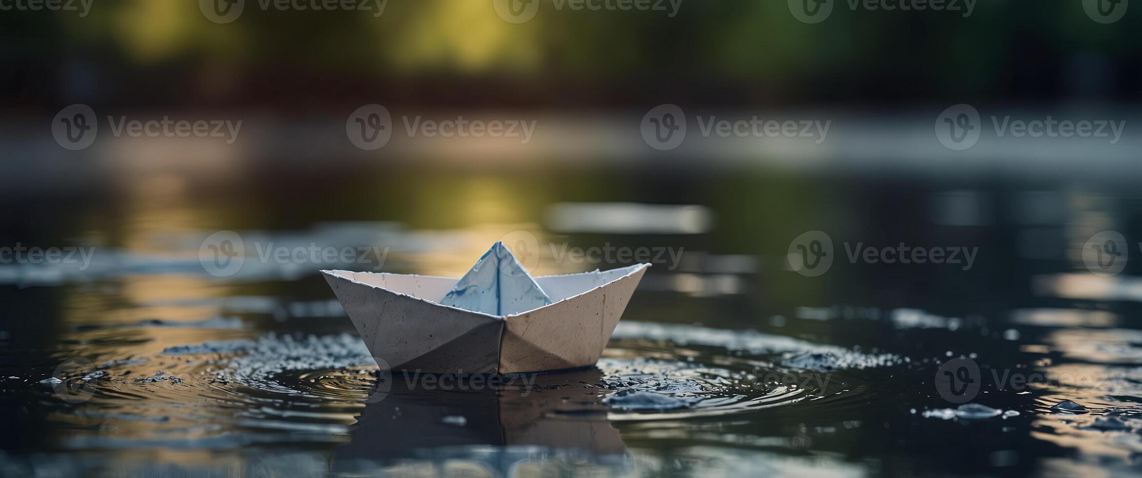 A puddle of water with a floating paper boat. photo