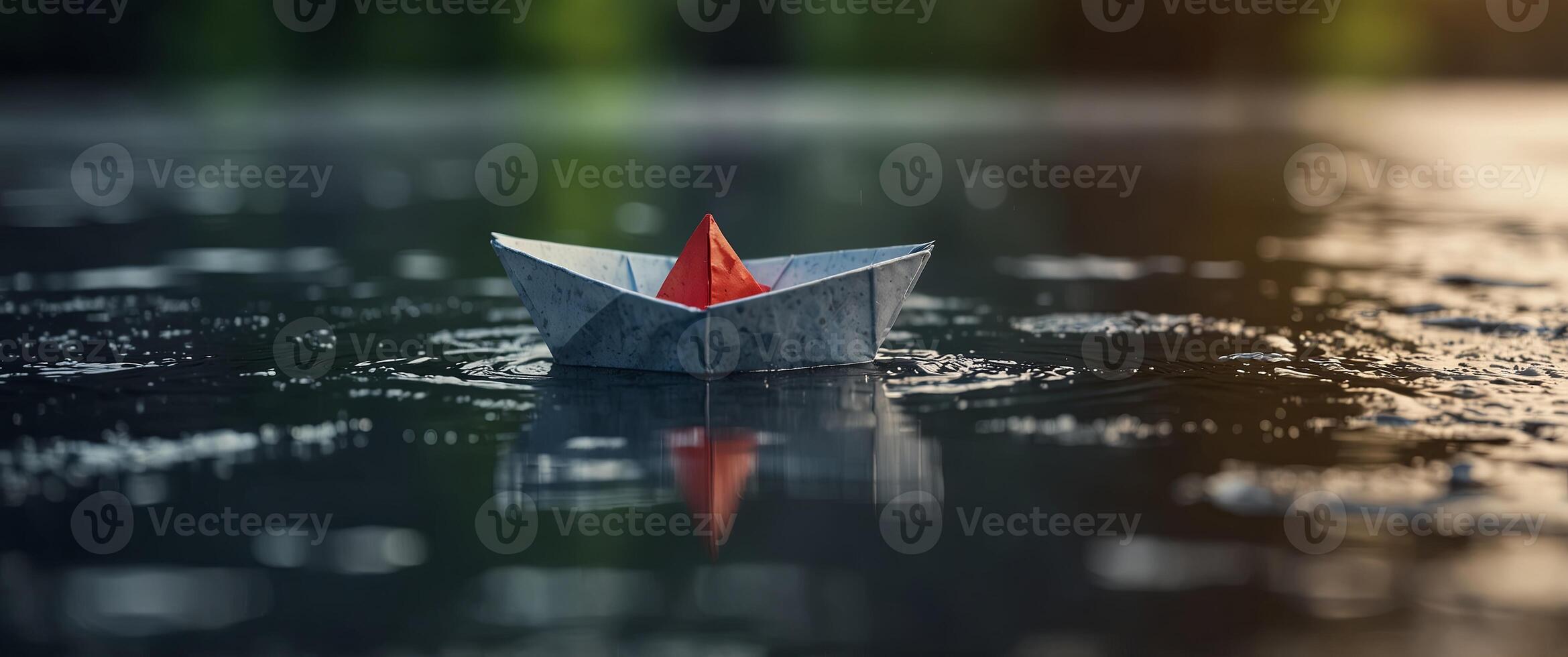 A puddle of water with a floating paper boat. photo