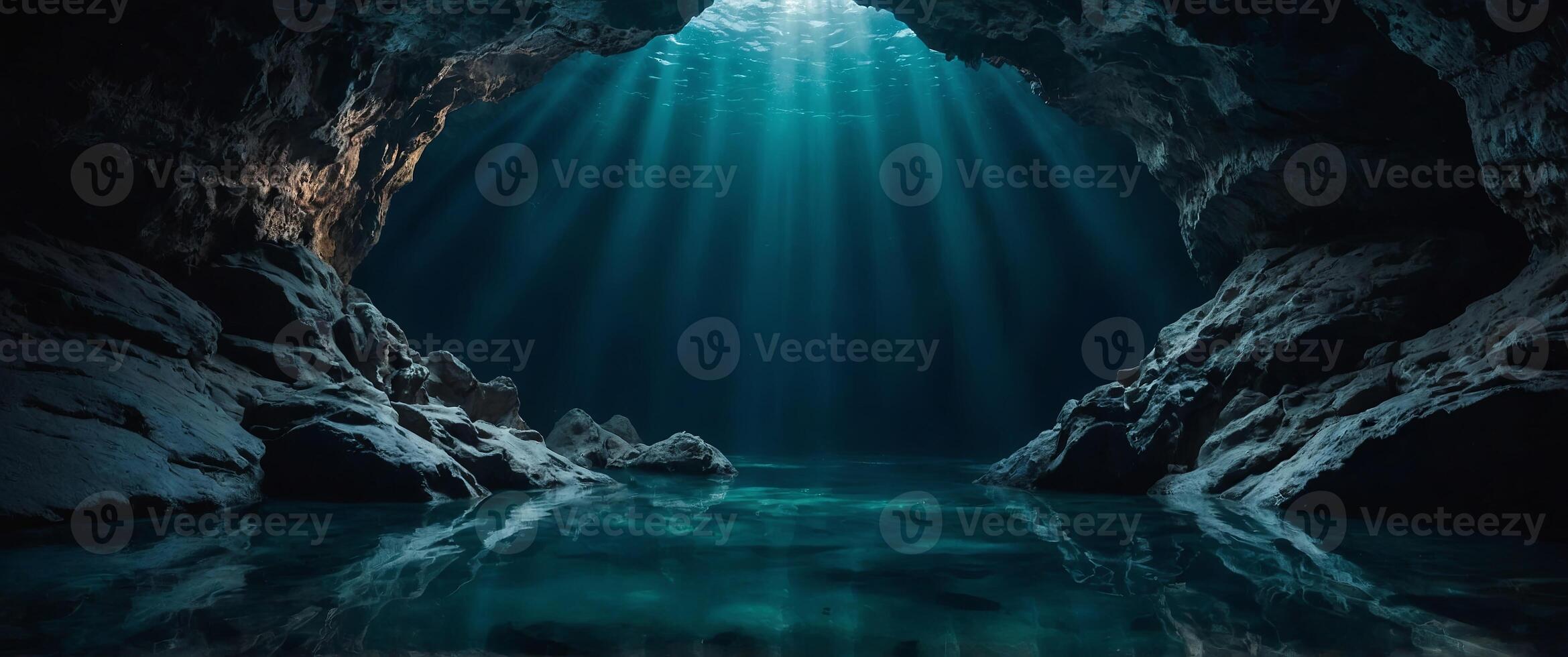 A deep, dark cave with a pool of water at the bottom. photo