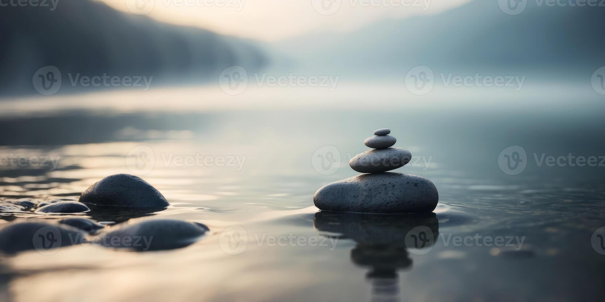 Two Zen stones in water with fog in the background. photo