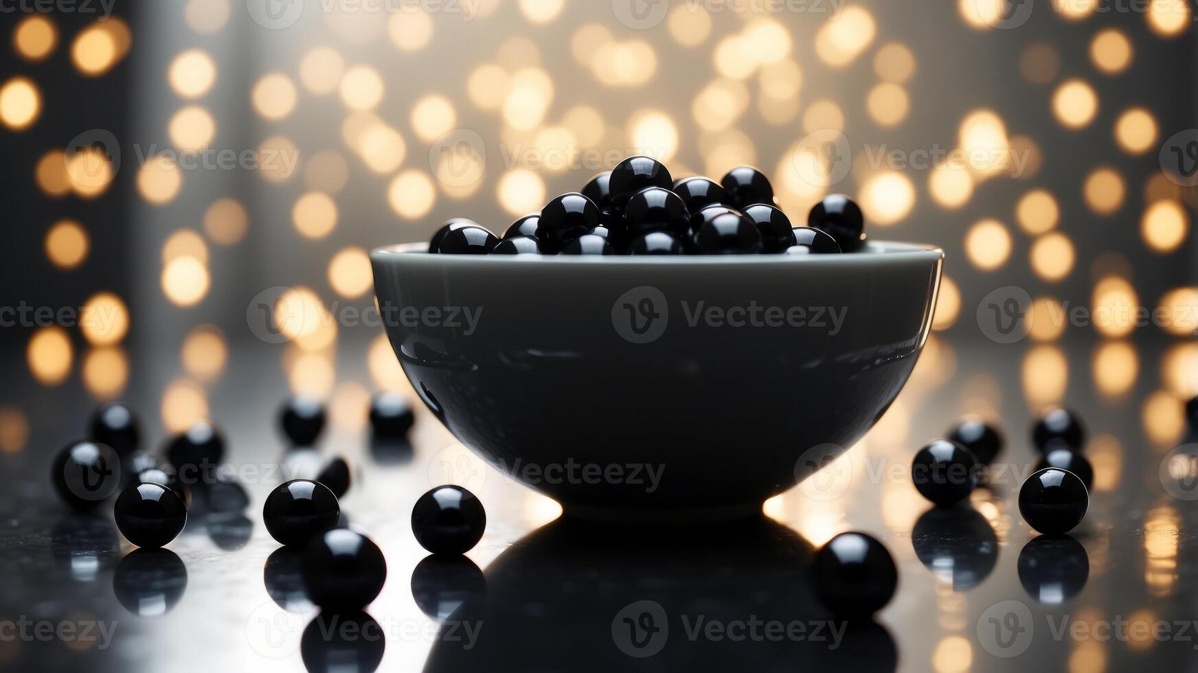 White bowl filled with shiny black beads on reflective surface. photo