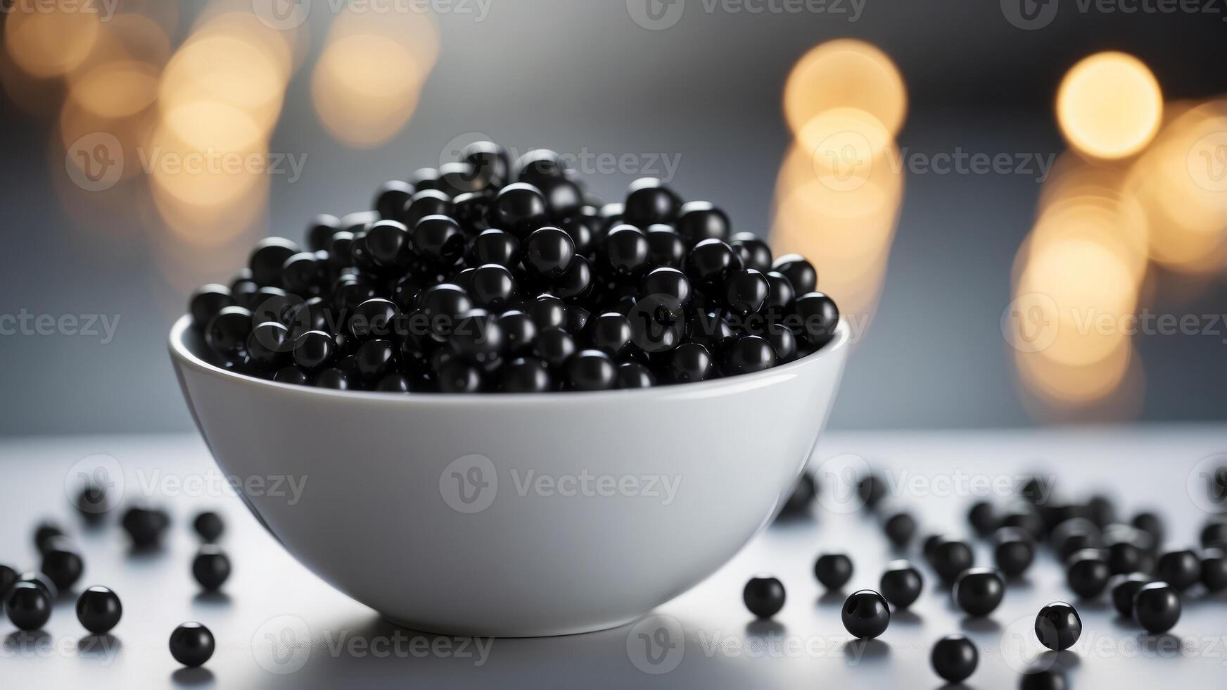 White bowl filled with shiny black beads on reflective surface. photo