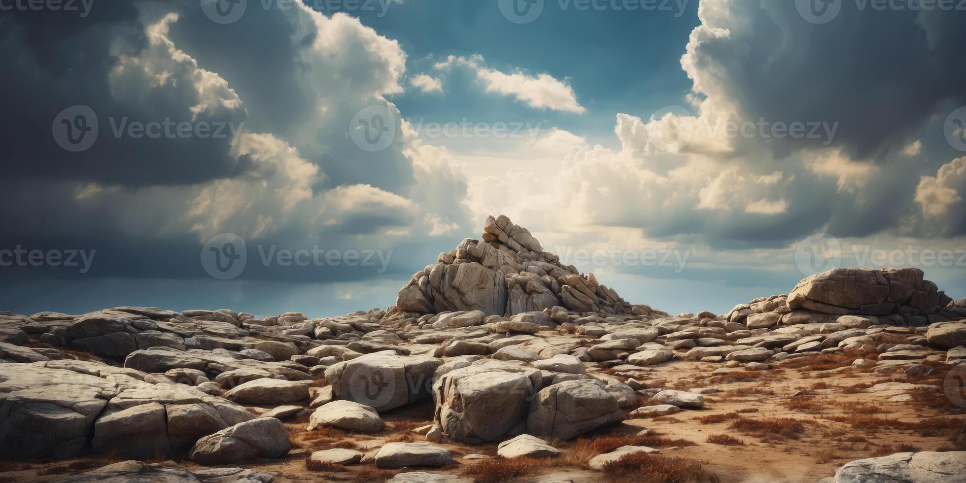 View of a woneter from behind lonerge rocks, A sky with donerk cloudy over on boneckground. photo