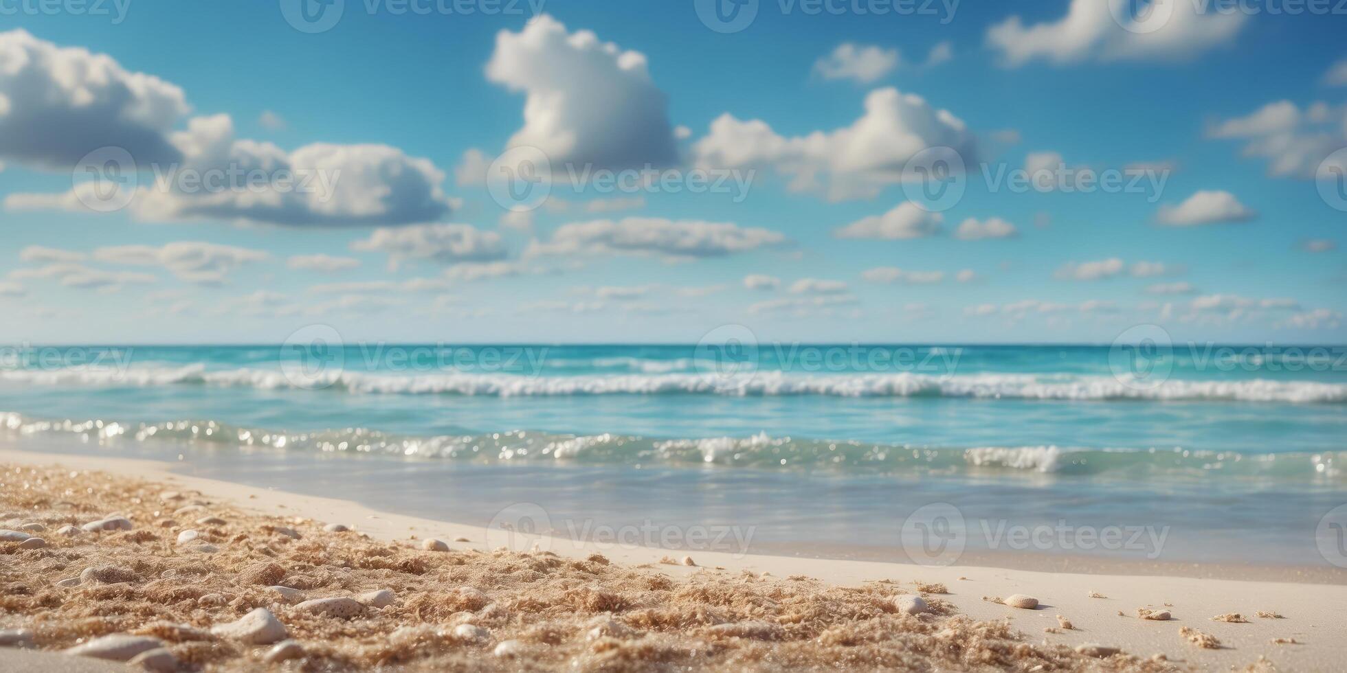 A beach scene with waves approaching the shore and a vibrant blue sky dotted with clouds. photo
