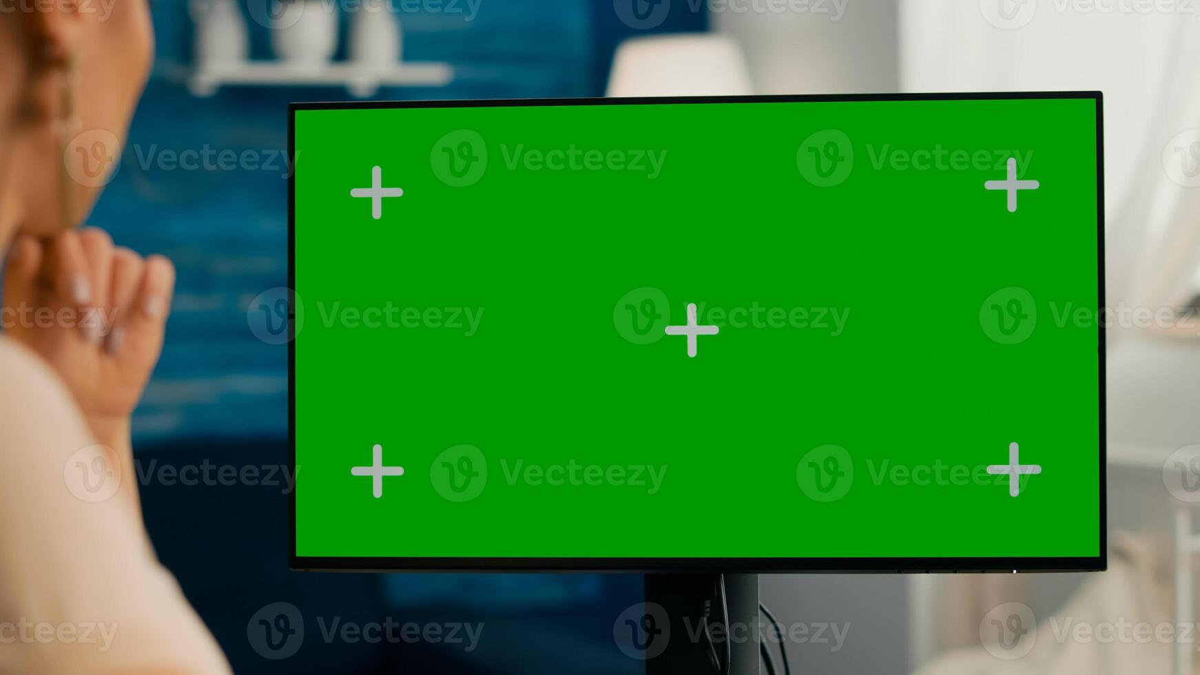 Close up of woman having videocall conference on personal computer with mock up green screen chroma key sitting at home office space. Business female working with teammates using isolated pc photo