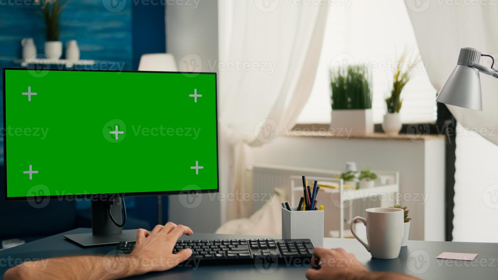 Pov of man hands sitting on office desk using computer with mock up green screen chroma key working photo
