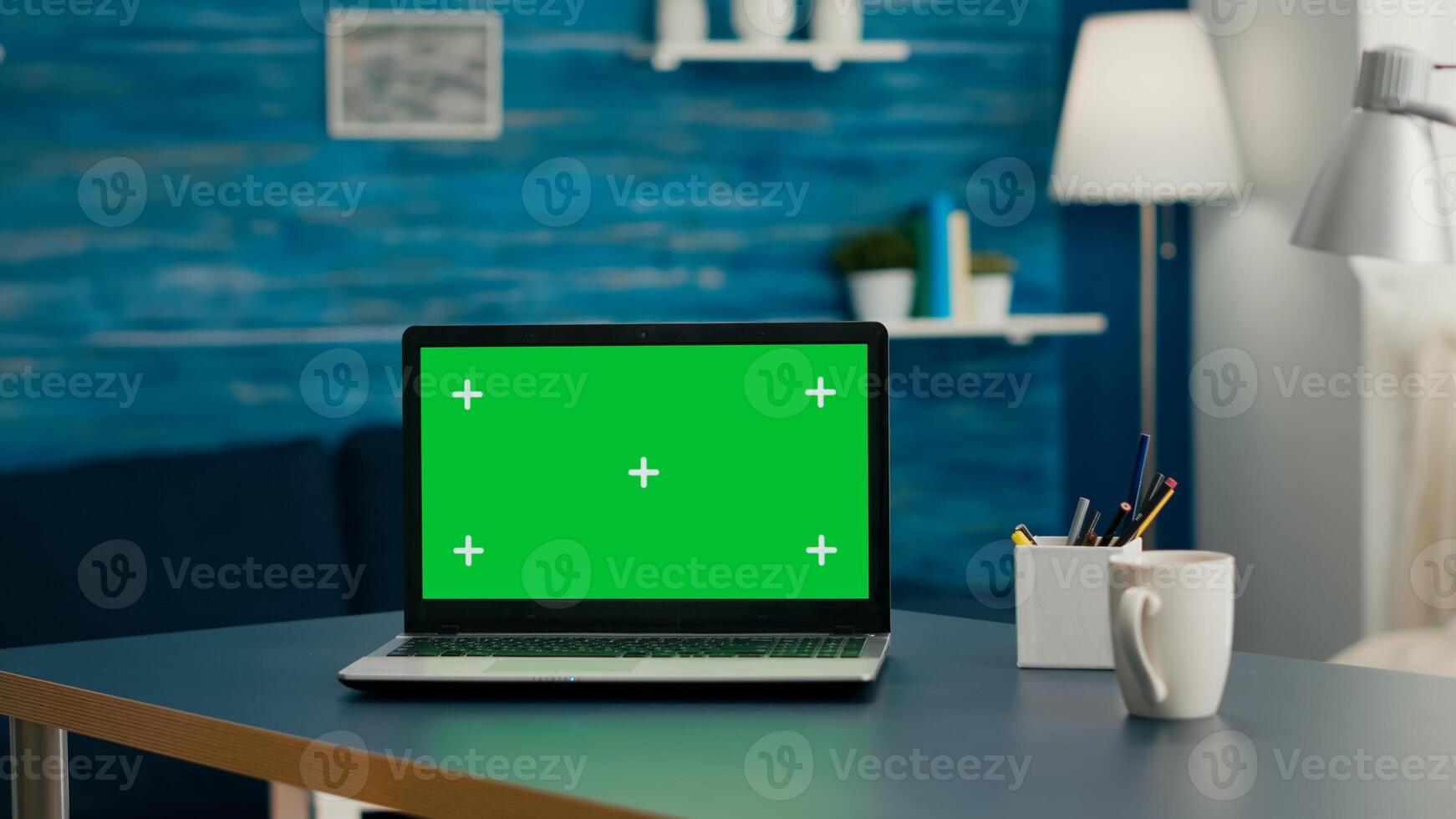 Empty home office with nobody in it is ready for online comunication courses using isolated pc. Laptop computer with mock up green screen chroma key sitting on desk in bright living room photo