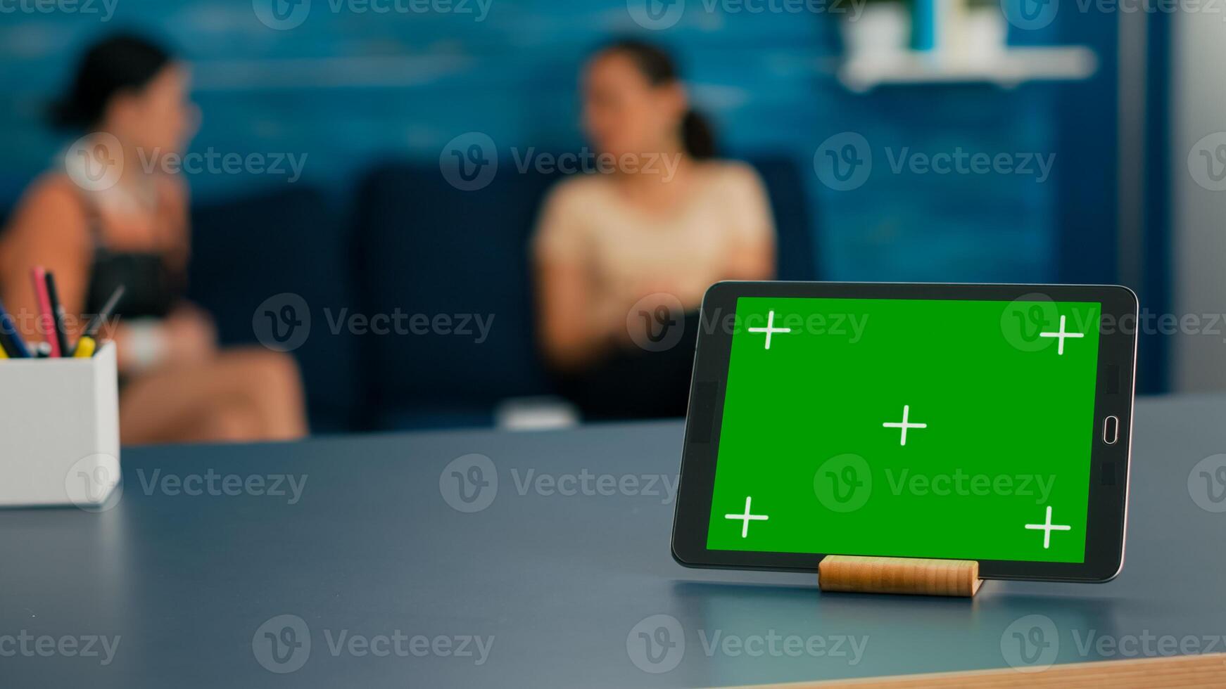 Laptop computer with mock up green screen chroma key display it is used for online connection standing on office table. Women talking about isolated pc in living room background photo