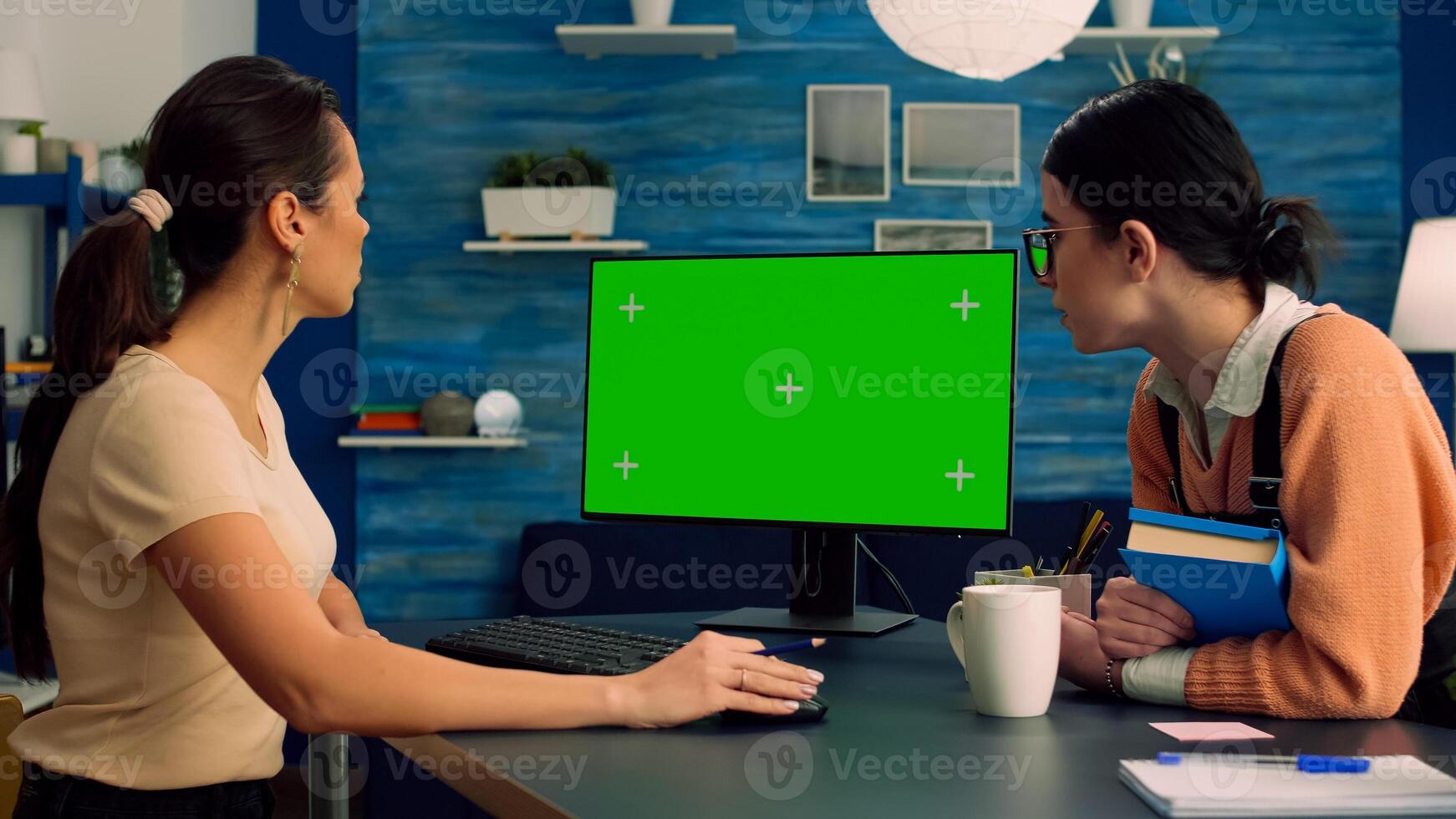 Teammates browsing on internet for commerce advertising using powerful computer with mock up green screen chroma key display. Collegues working on isolated pc sittings at desk table in office studio photo