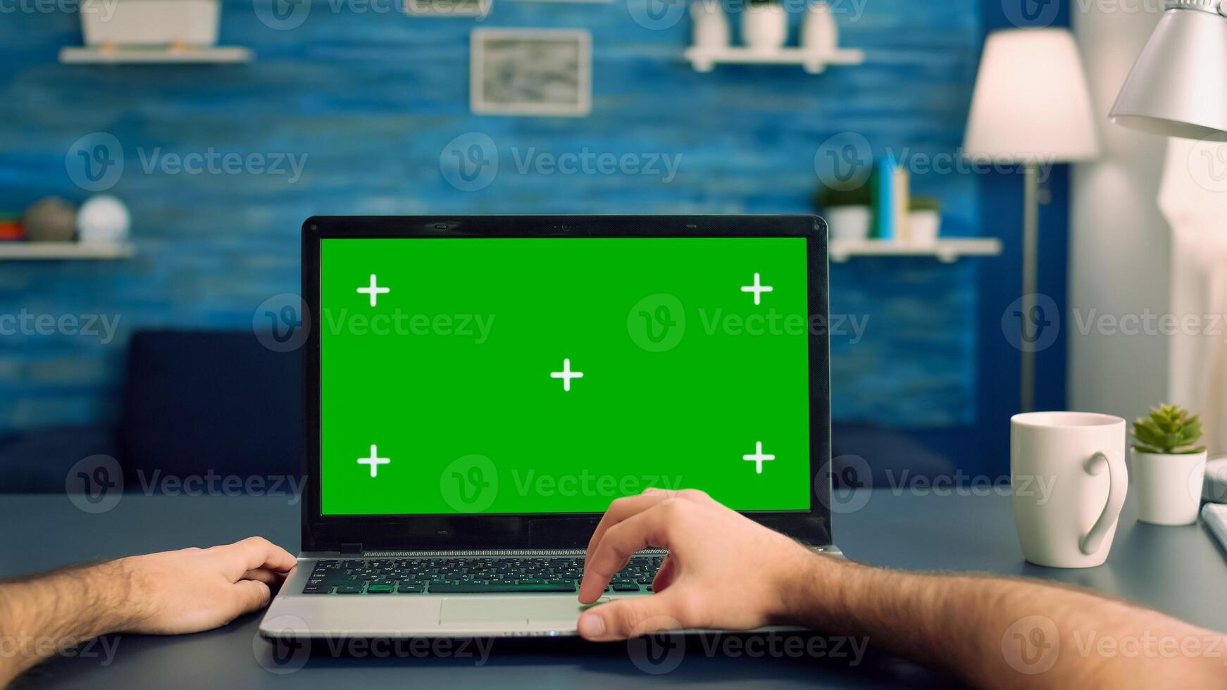 Point of view of man hands typing on laptop computer with mock up green screen chroma key display for e commerce courses. Freelancer using isolated device standing on desk table in home office studio photo