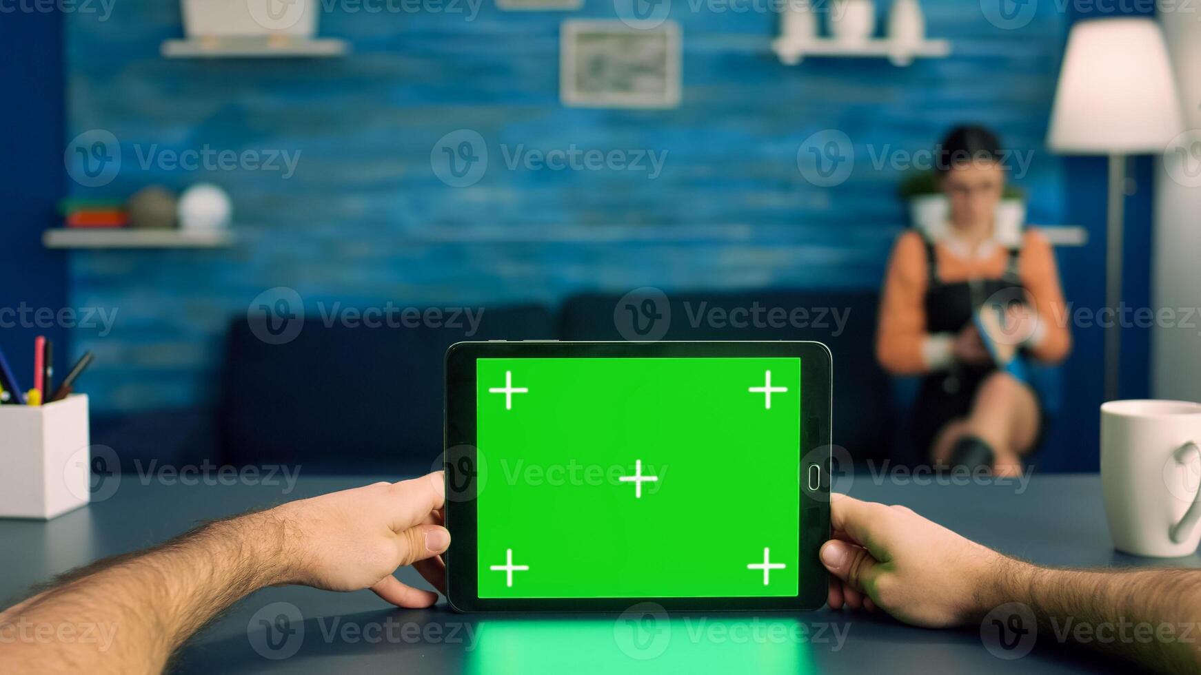 Point of view of business man hands holding tablet computer with mock up green screen chroma key display standing on desk table. Caucasian male using isolated device for digital advertising photo