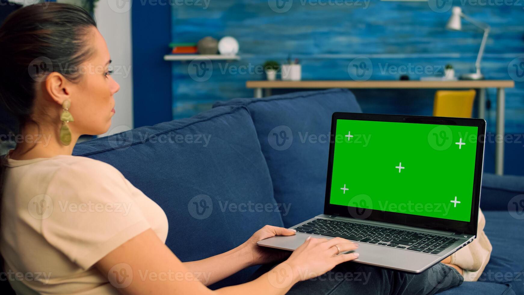 Business woman working on laptop computer with mock up green screen chroma key digital display. Caucasian female typing on keyboard writing ideas for marketing project using powerful isolated pc photo