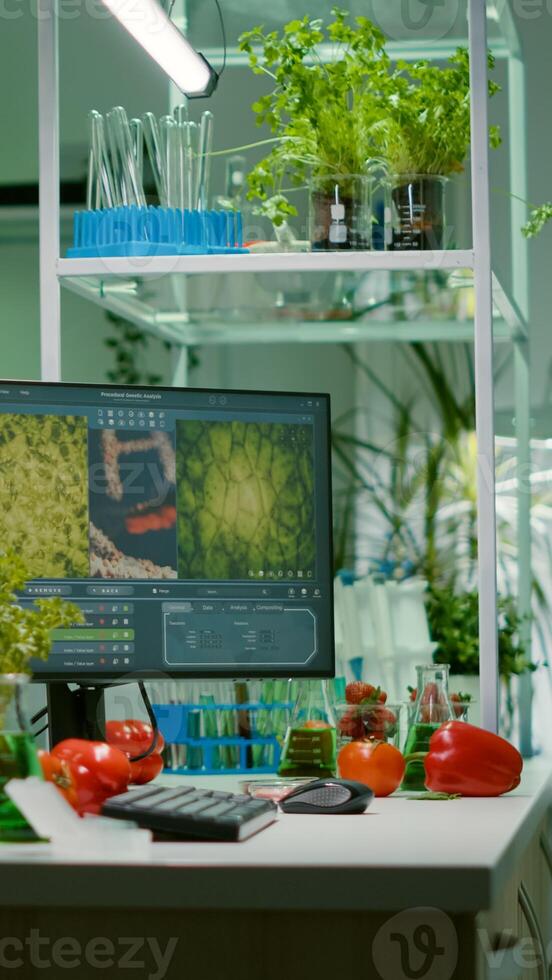 Empty laboratory with nobody in it prepared for genetic test using professional microscope. Biochemistry lab eqquiped with high tech tools for pharmaceutical plant GMO biology medical research test photo
