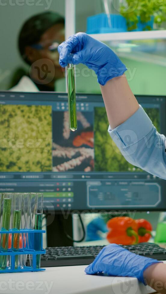 Biochemistry doctor examining chemical test under microscope for genetic researcher. Biologist specialist discovery organic gmo plants while working in microbiology food laboratory photo