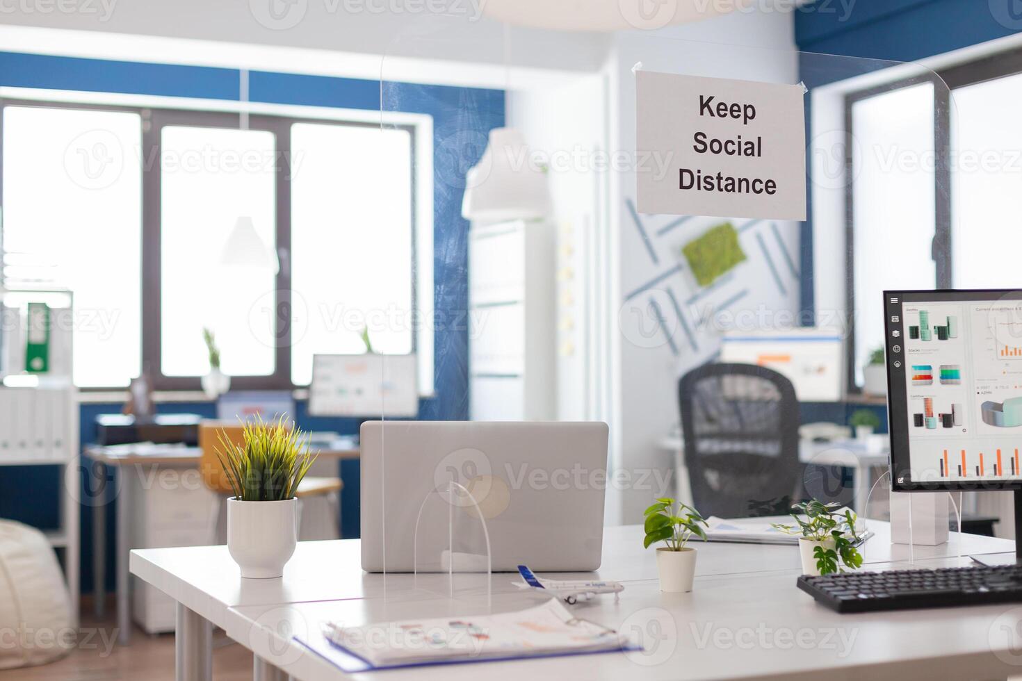 Modern empty office interior with plastic separators and keep social distance poster on the walls. Empty corporate space business interior with nobody in it. photo