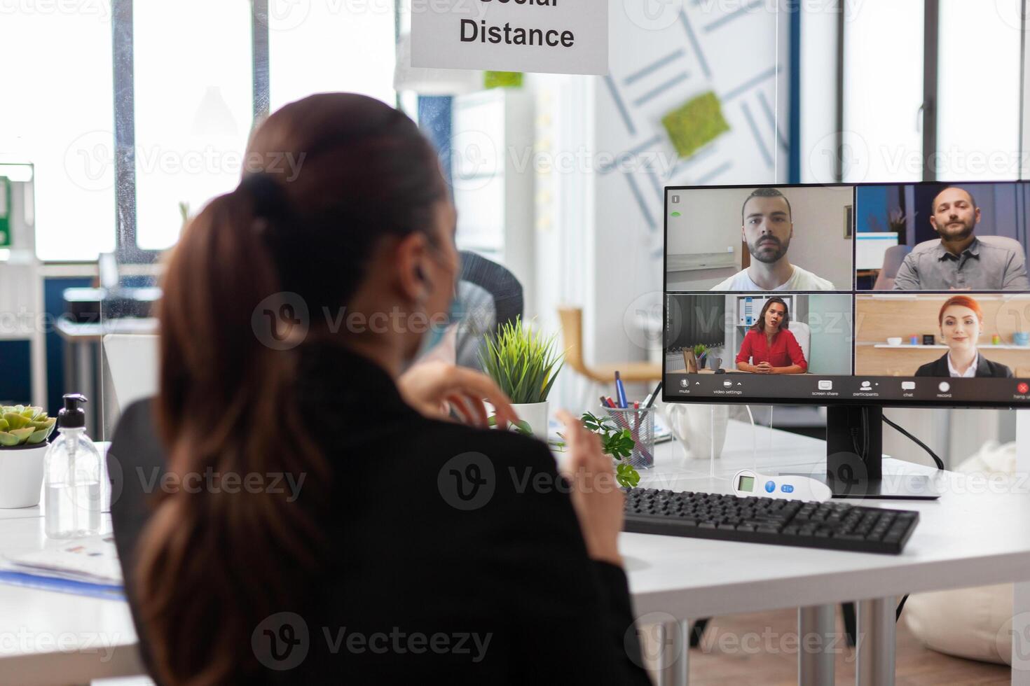 Businesswoman discussing with remote business team during online videocall meeting conference on computer working at management strategy in startup company office. Teleconference call on screen photo