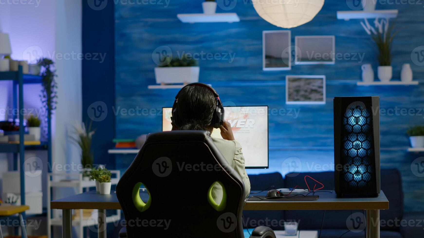 Angry african pro woman gamer losing space shooter videogame during online championship. Cyber player testing virtual games using powerful personal computer in gaming room during esports tournament photo
