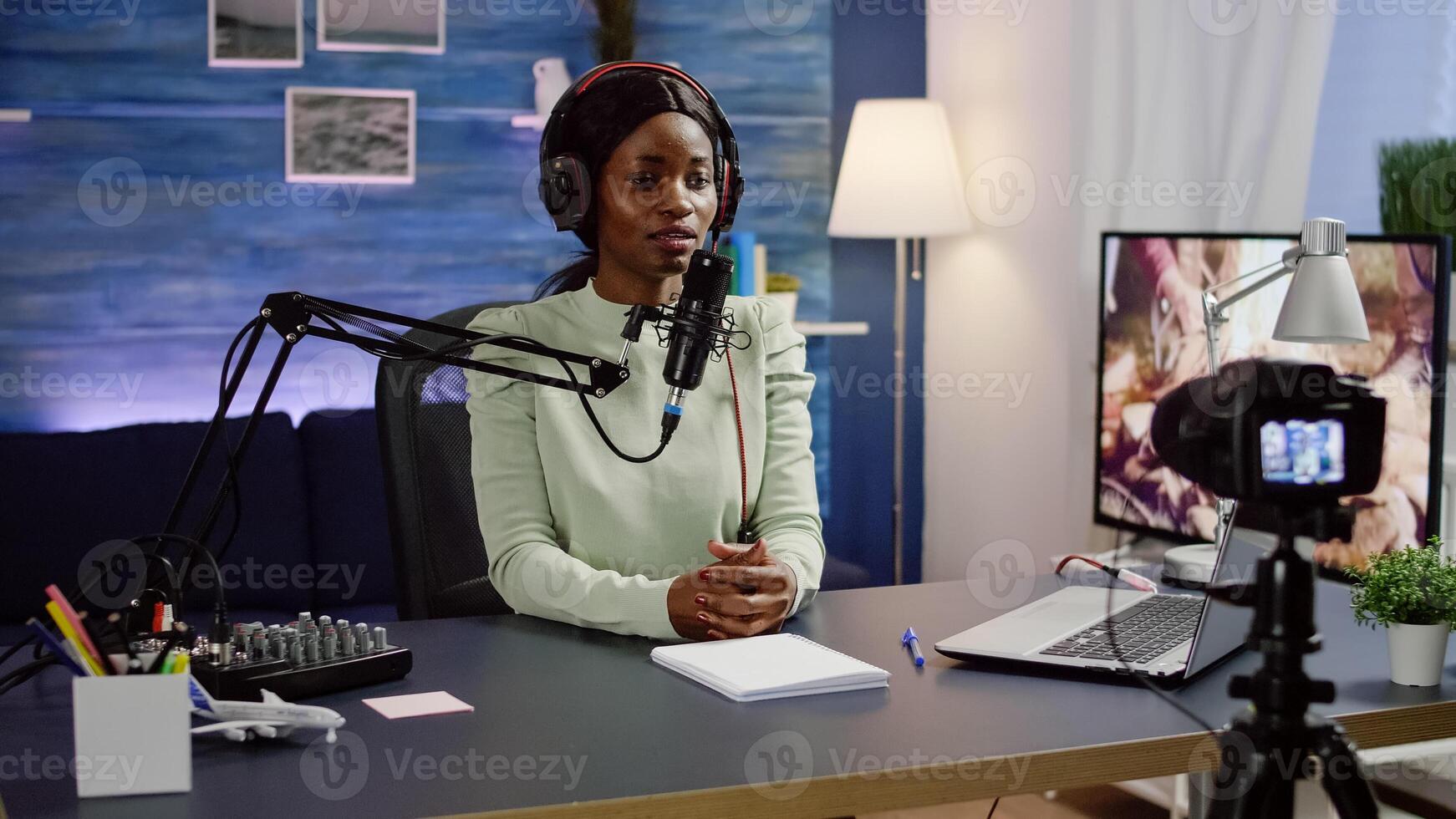 Black blogger sitting at home vlog station while camera recording new podcast. Online show On-air production internet broadcast host streaming live content, recording social media communication photo