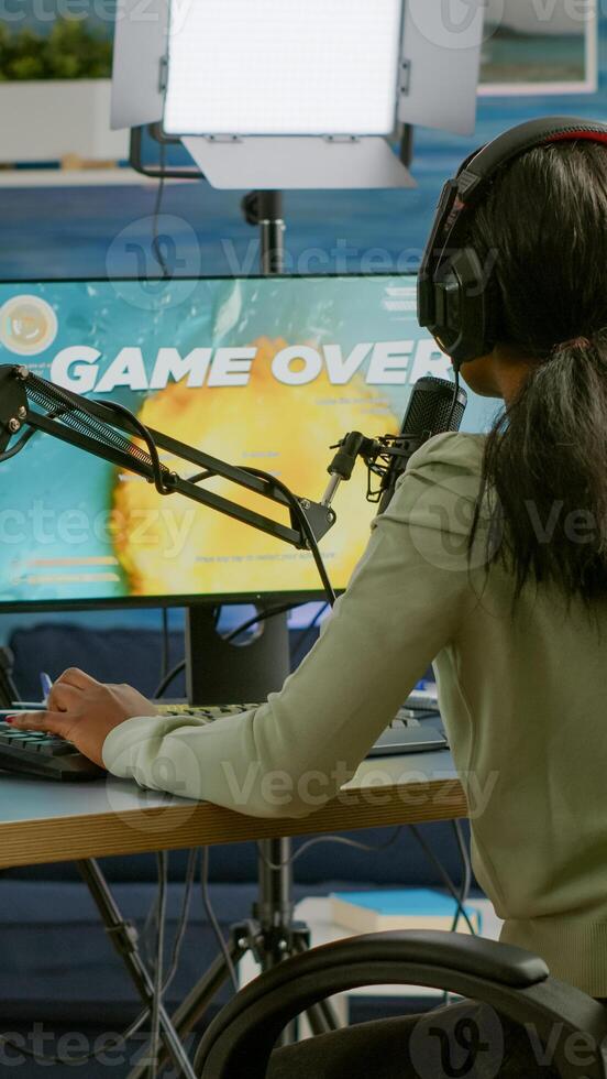 Black esport streamer being upset losing space shoot game championship playing on RGB computer. Professional gamer streaming online games with new graphics on powerful pc. photo