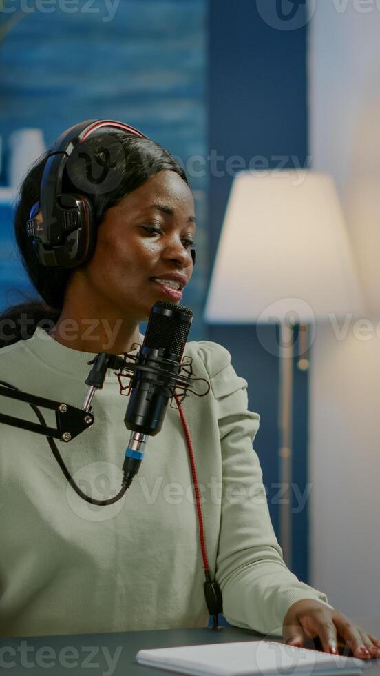 Influencer making online internet content for web subscribers using camera in home podcast studio during livestreaming. On-air online production broadcast show host streaming live content photo