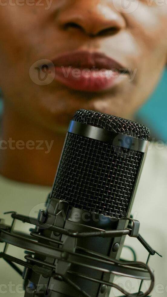 Close up of famous woman recording a vlog for subscribers using podcast microphone for vlogging. On-air online production internet broadcast show host streaming live content for social media photo