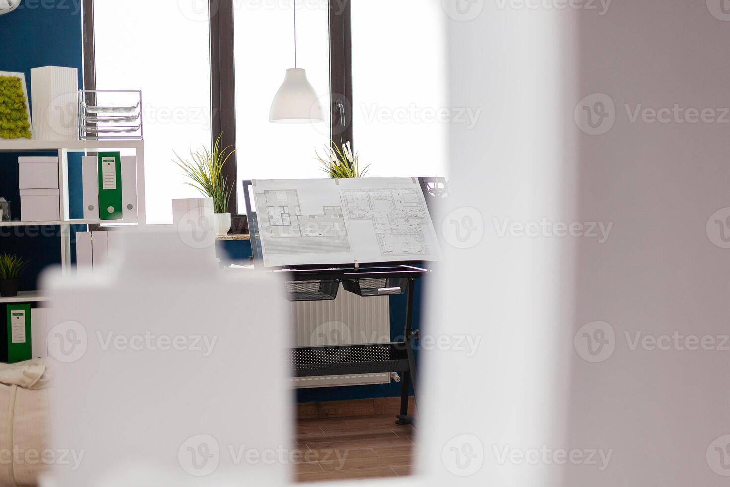 Stand with drawing plans for real estate development in modern architect open space office. Architectural design board with blueprints for urban planning building complex . photo