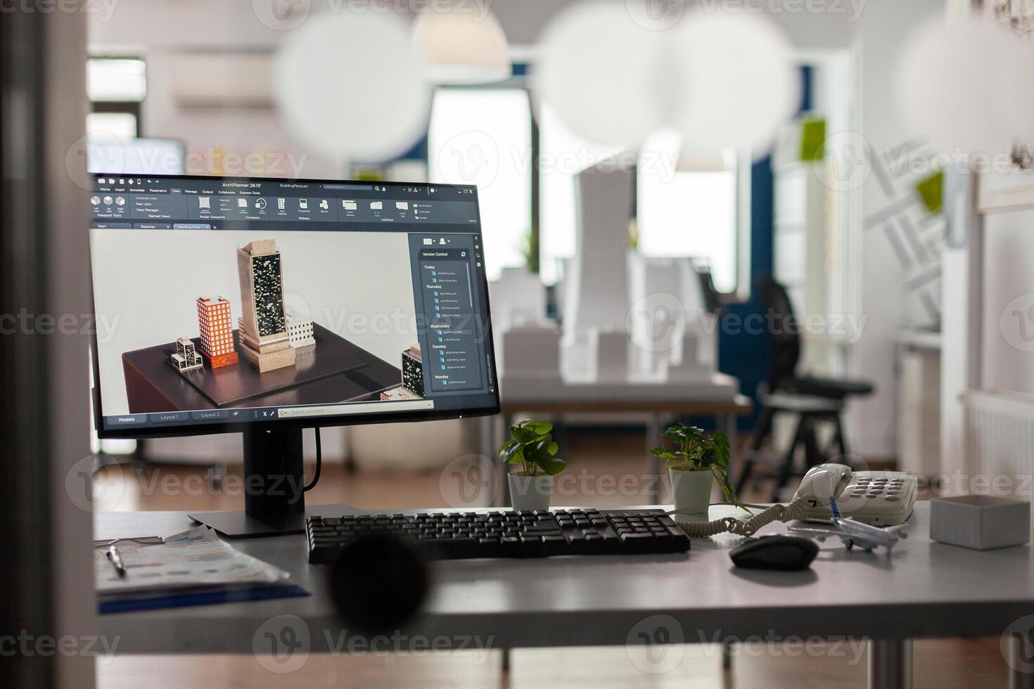 Closeup of modern architect desk with workstation showing 3d blueprints of architectural building complex. Desktop screen showing model of urban planning architecture construction plan. photo