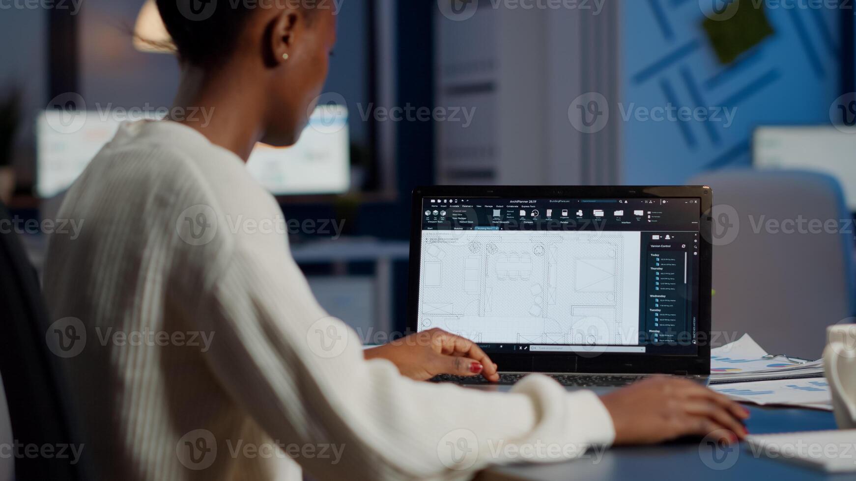African engineer constructor designer architect analysing new bluilding plan in CAD program working in business office. Industrial woman employee studying prototype idea showing cad software on device display photo