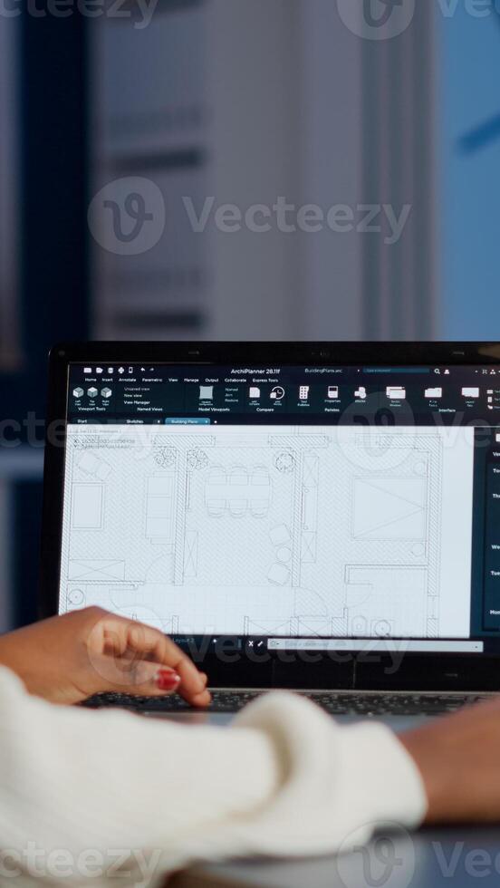 African engineer constructor designer architect analysing new bluilding plan in CAD program working in business office. Industrial woman employee studying prototype idea showing cad software on device display photo