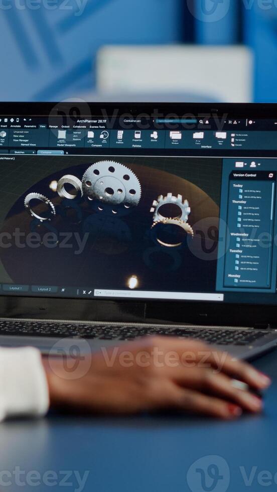 African woman engineer working at new project using laptop doing overtime at night sitting at desk in start-up office. Industrial construction designer studying on pc showing cad software in midnight photo