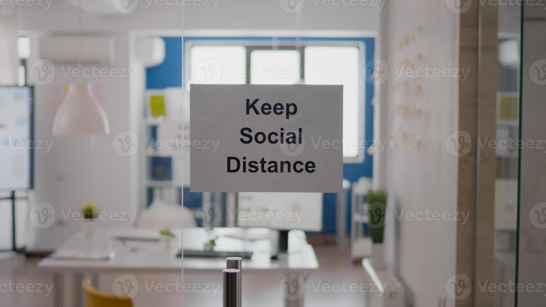 Business glass interior office with keep social distance sign on the wall. Modern office space with nobody in it during global pandemic, coronavirus crisis photo