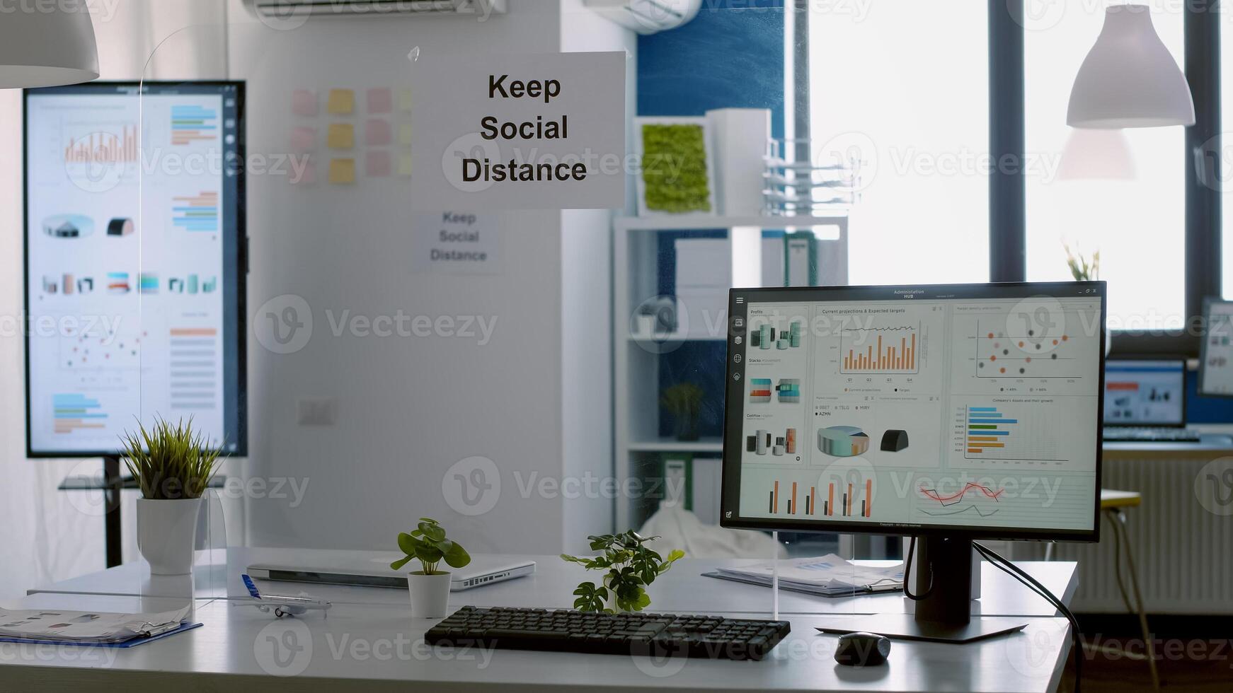 Modern empty office with plastic separators and keep social distance poster on the walls. Empty corporate space business interior with nobody in it photo