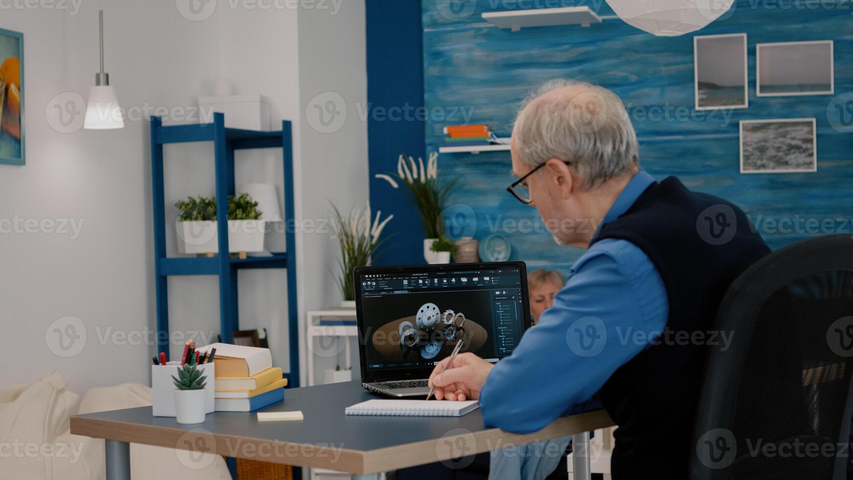 Senior remote man architect working on modern cad program analysing gears design. Industrial old engineer studying prototype idea on laptop computer showing cad software on device display photo
