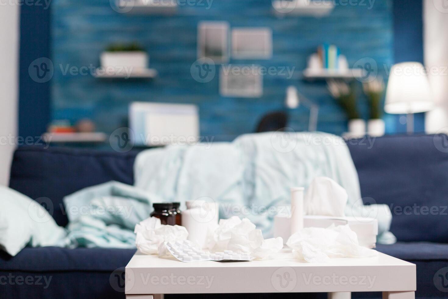 Empty room with medical treatment napkins and pills against cold flu virus disease illness. Bottles with medicine and drugs lying on the table in the bedroom photo