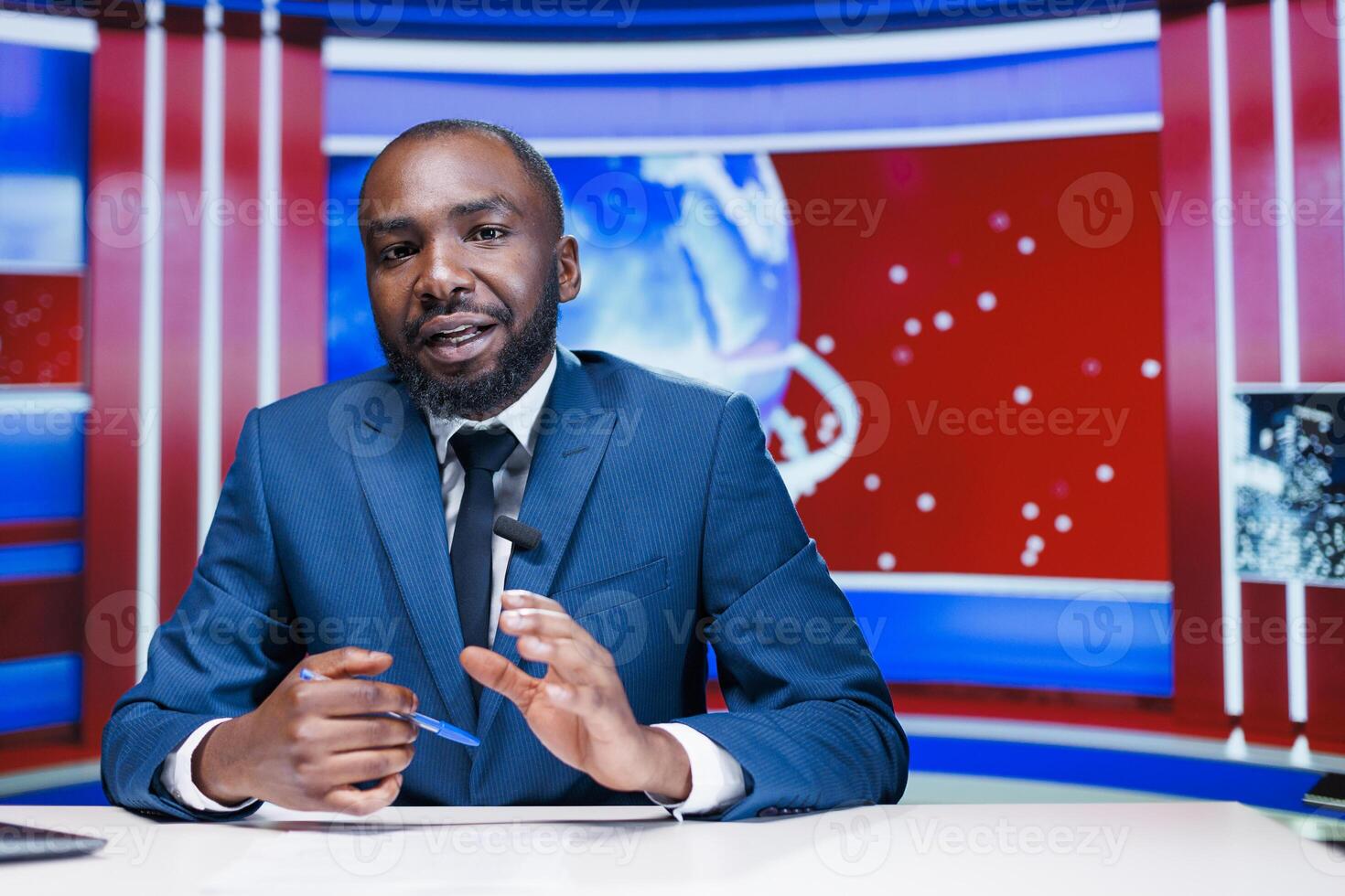 Presenter broadcasting tv content from media studio, reading headlines to create powerful emotional story. African american news reporter giving updates about latest events worldwide. photo