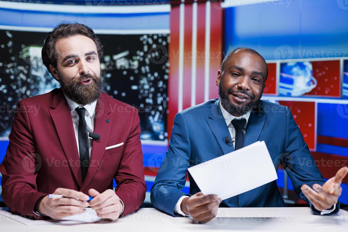 Diverse newscasters covering all topics on late night talk show, presenting latest news on worldwide events. Journalists team reporting live information from media outlets, newscast content. photo