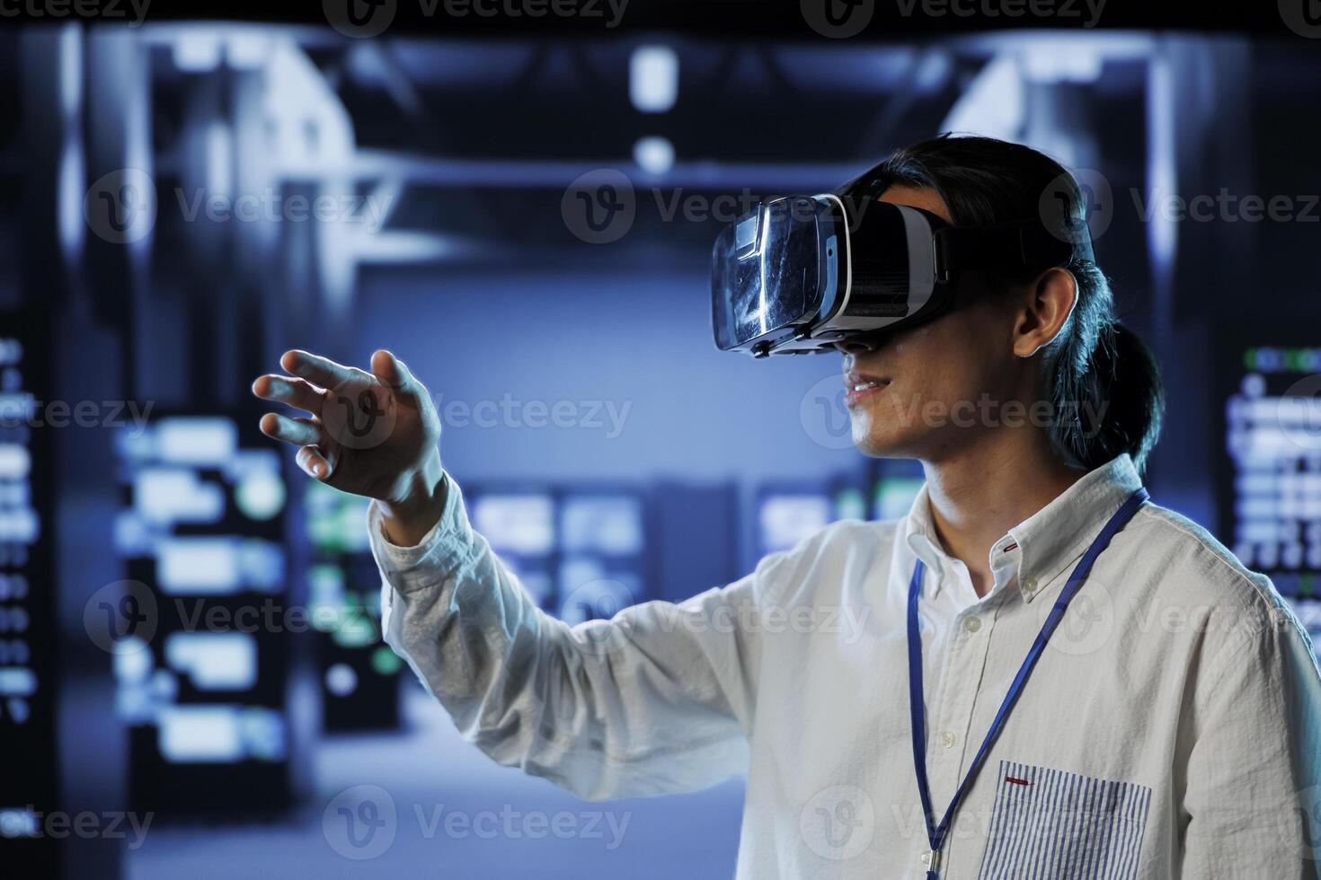 Qualified programmer in data center uses virtual reality to prevent system overload. Specialist with VR goggles in server hub ensuring enough network bandwidth for smooth operations photo