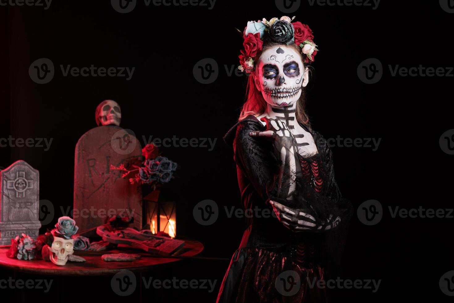 Woman with flower wreath participating at Dia de los Muertos party, preserving cultural traditions from one generation to the next. Spooky lady wearing la Catrina garments to celebrate Mexican culture photo