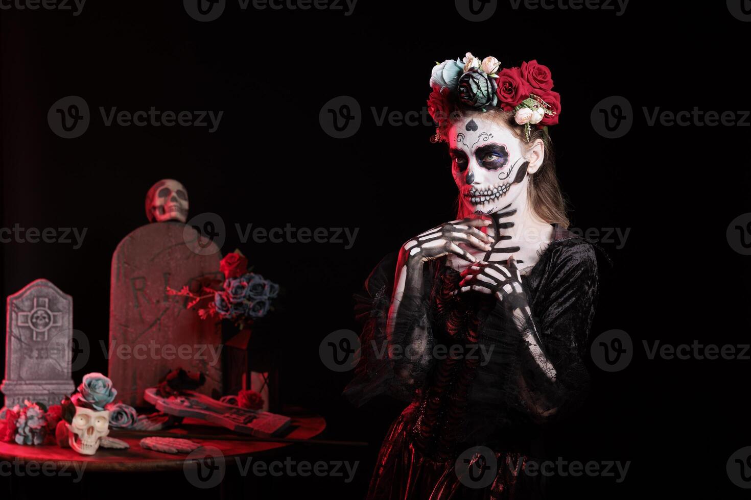 Woman wearing corpse makeup and horror costume to celebrate dios de los muertos during Mexican event. Frightening lady dressed as goddess of death character on day of the dead fiesta photo