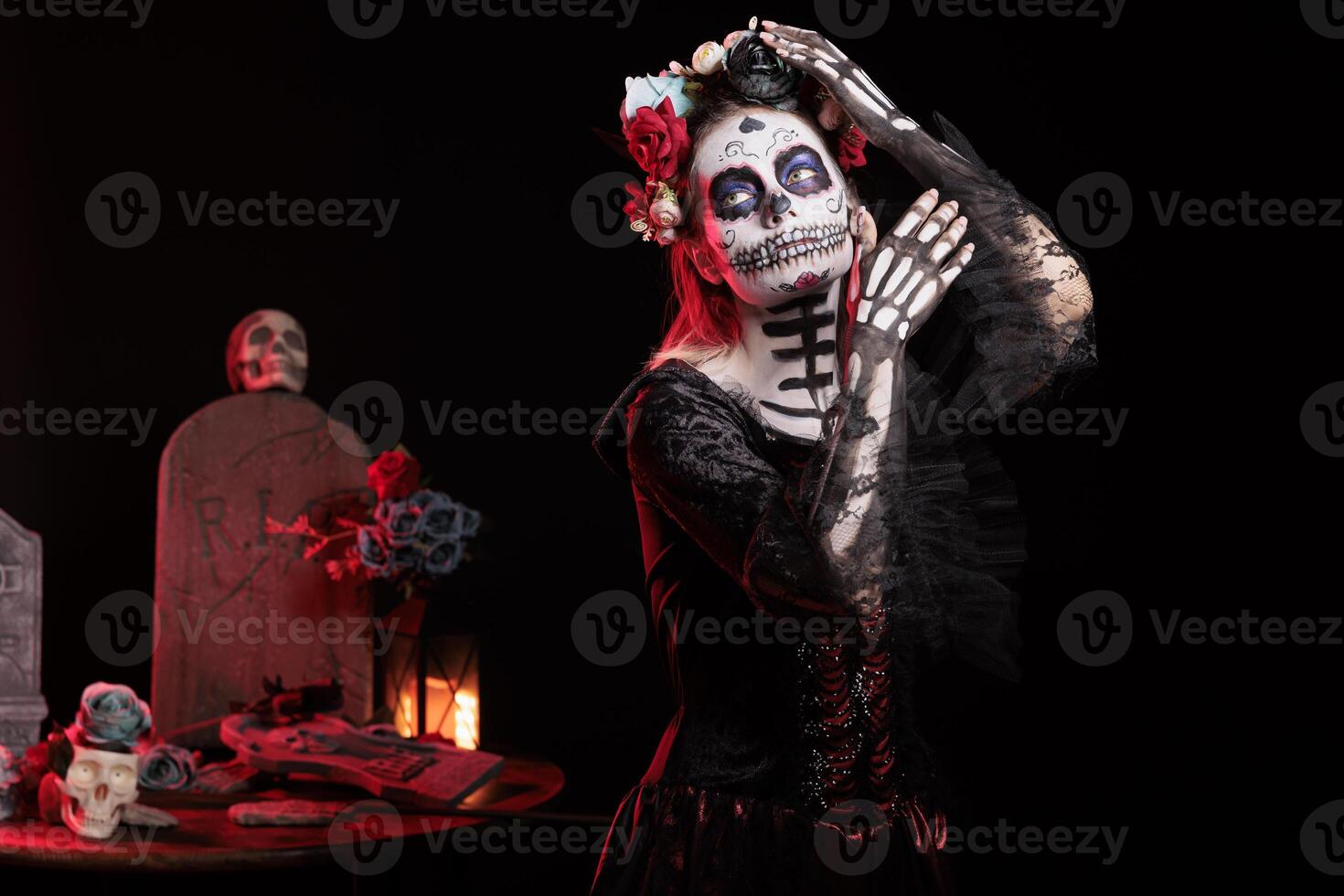 Portrait of woman during Day of the Dead Mexican event honoring dead loved ones, grave site background. Scary lady acting as La Catrina character during ancient Aztec custom of celebrating ancestors photo