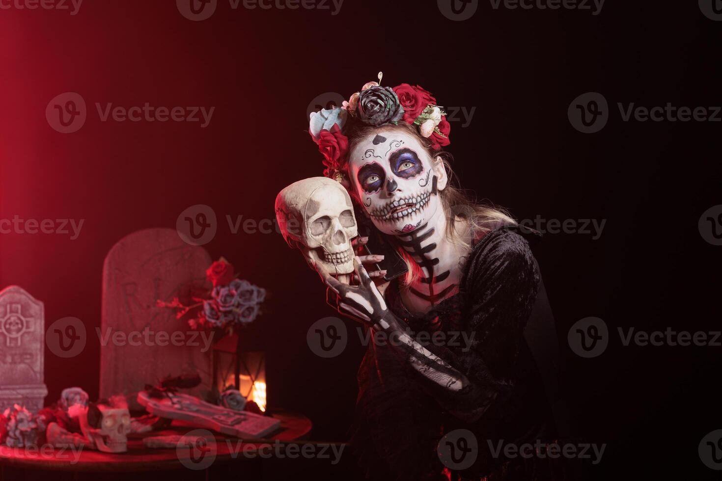 Lady putting phone to skull ear at religious processions during Dia de los Muertos, talking with dead loved ones. Woman discussing with ancestors in telephone call, showing reverence for deceased photo