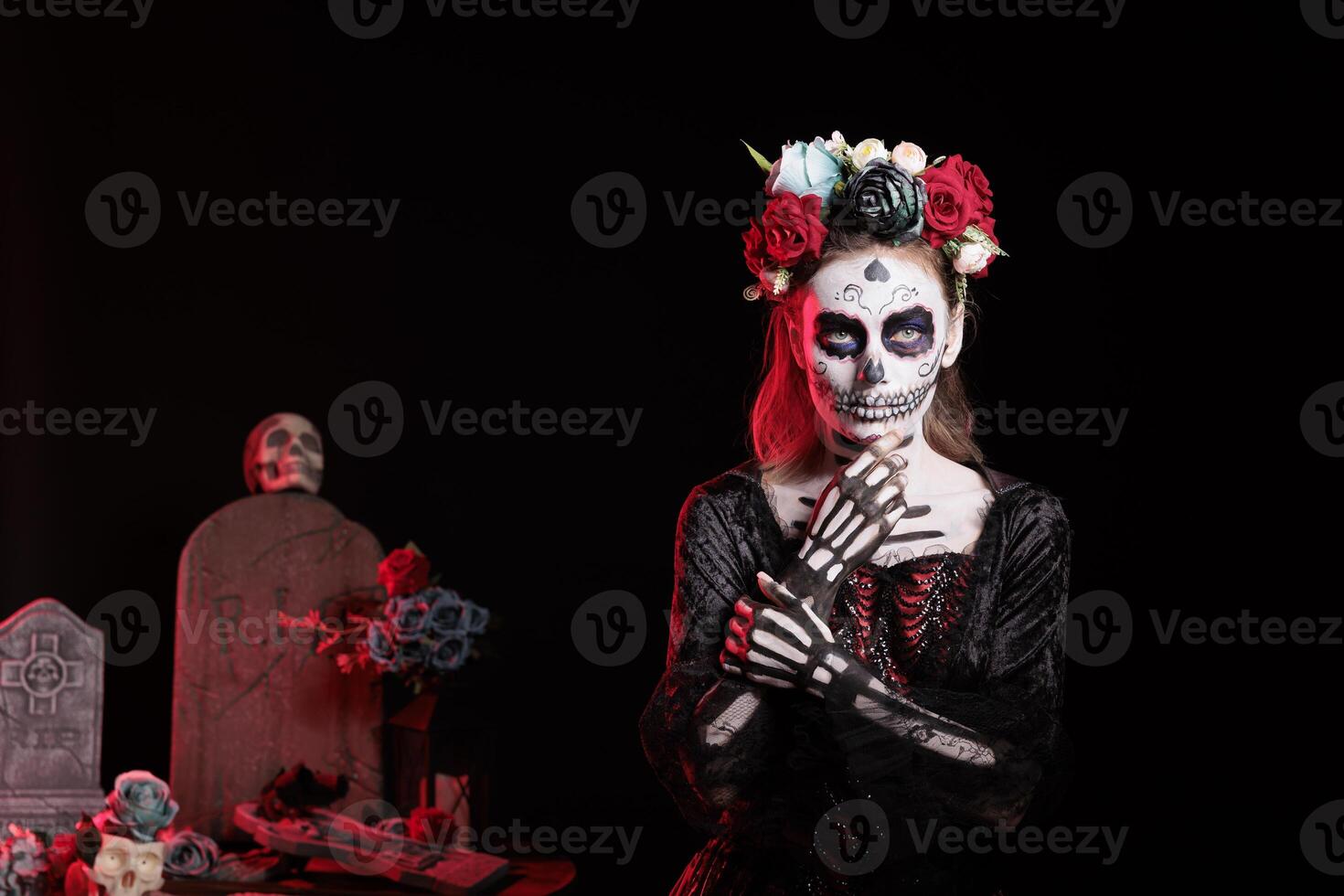 Person wearing skull makeup and horror costume to celebrate dios de los muertos during Halloween. Creepy woman dressed as La Catrina on day of the dead holiday, doing celebration photo