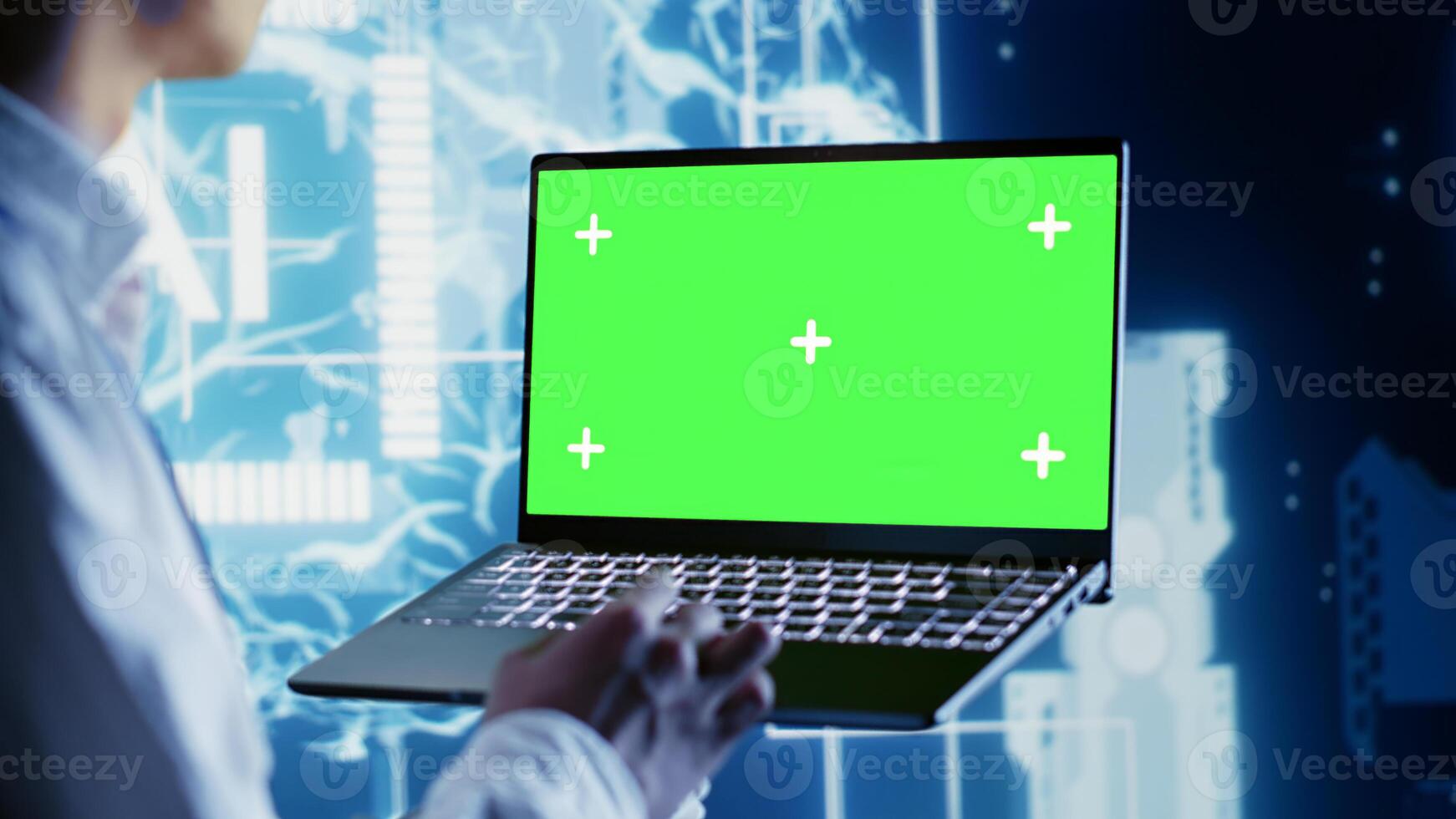 Computer scientist using chroma key laptop to write artificial intelligence script code in startup workplace. Dilligent worker doing maintenance work in data center, updating AI systems photo
