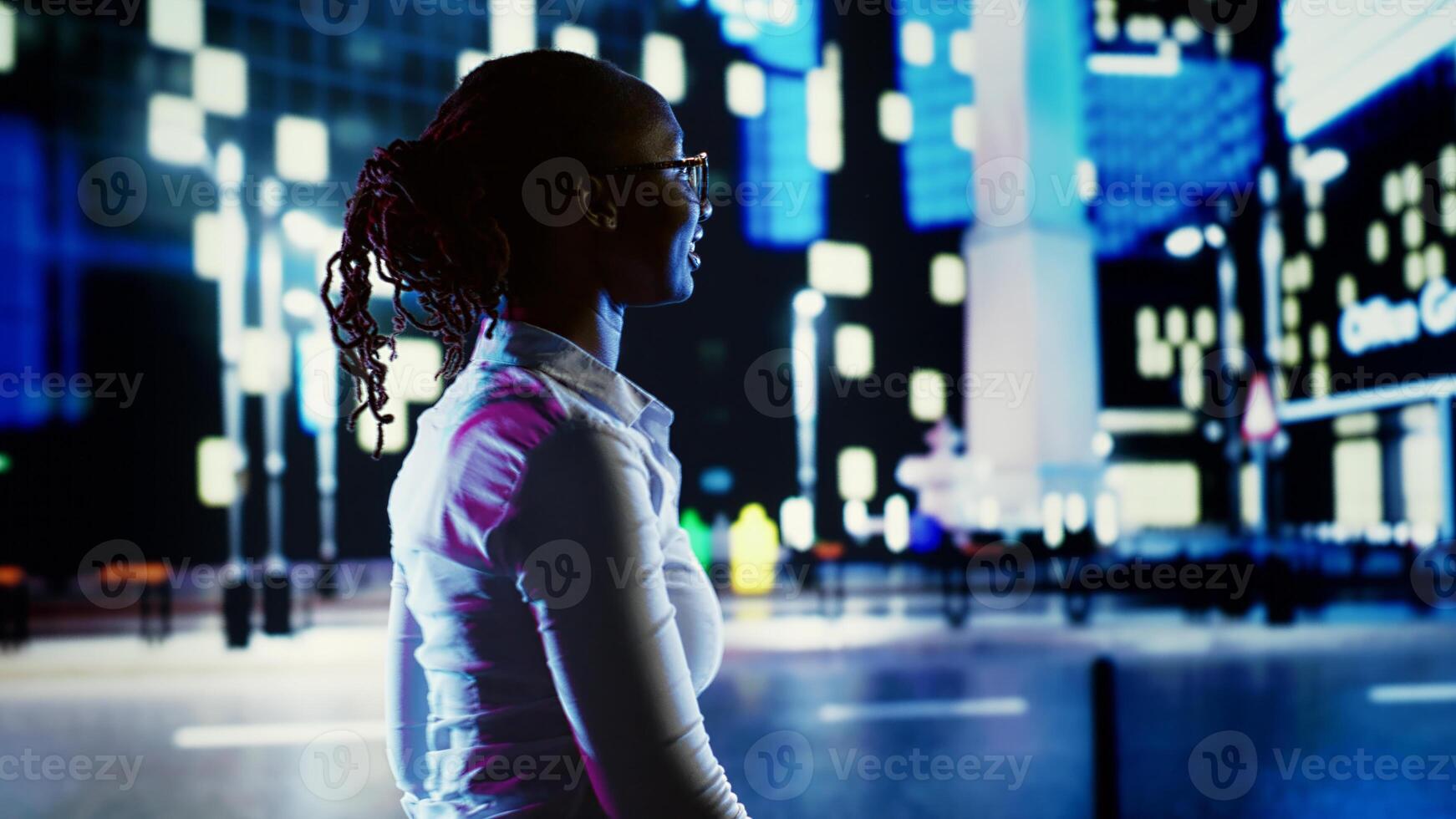 Euphoric person dancing around and greeting other people, walking on town boulevard during nighttime. Exultant woman enjoying herself while strolling on metropolitan avenues surrounded by skyscrapers photo