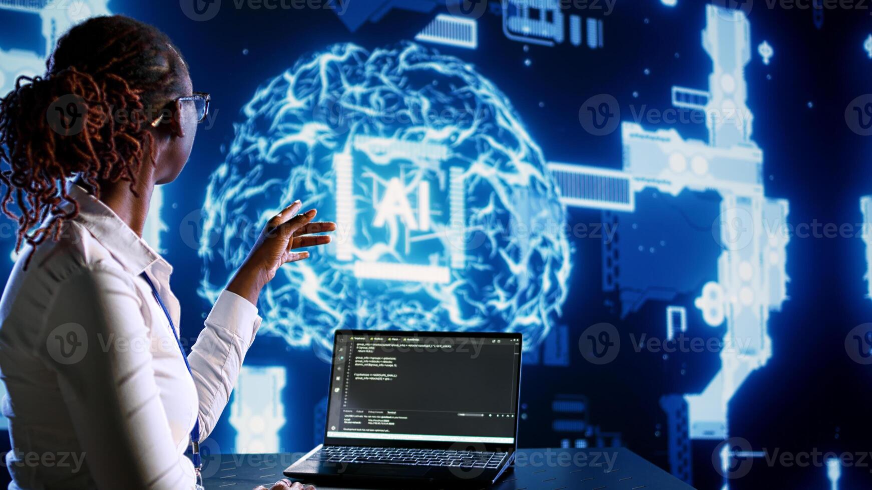 African american IT expert updating AI systems, writing intricate binary code scripts on tablet and laptop. Certified admin using programming to upgrade artificial intelligence simulation model photo
