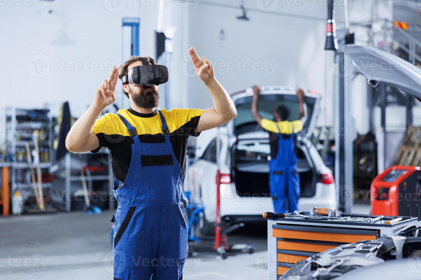 Mechanic in car service uses virtual reality to visualize automobile tires in order to fix them. Garage expert wearing high tech futuristic vr headset while refurbishing unfunctional vehicle photo