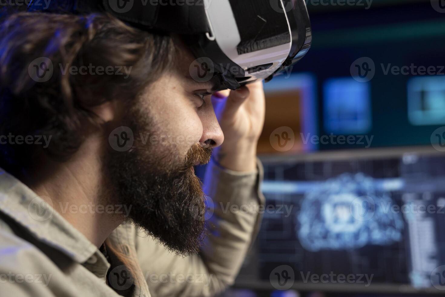 Cheerful admin using VR headset to chat with sentient artificial intelligence with own autonomy. Close up of smiling man at home talking with conscious AI superintelligence using virtual reality tech photo