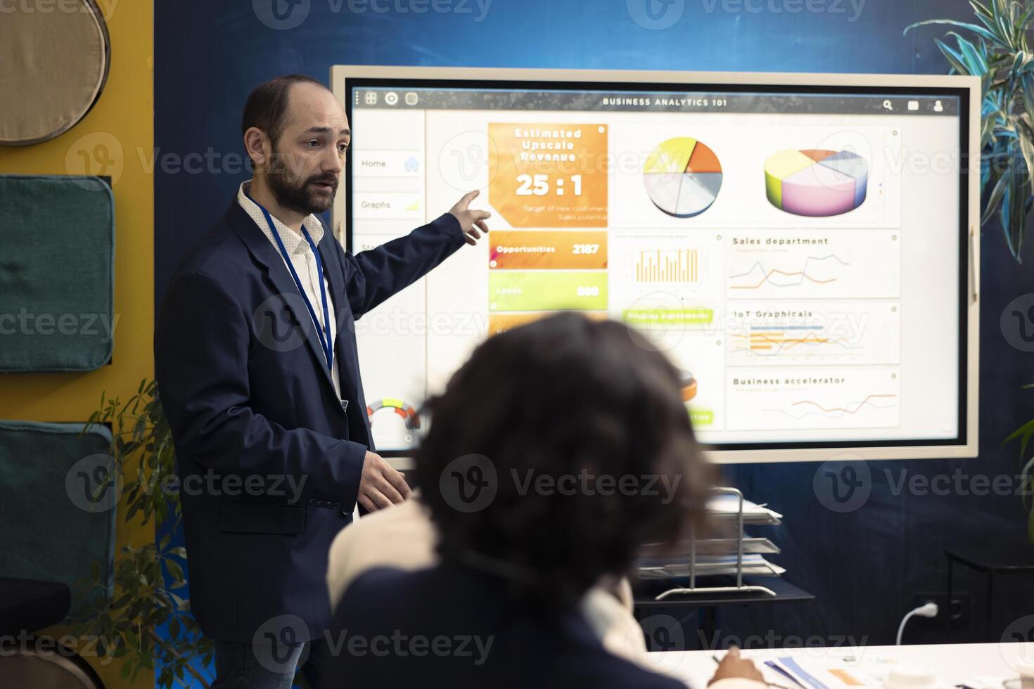 Executive officer analyzing infographics on sales to evaluate supply and demand, working with his staff to find ways of increasing corporation funds and develop the business internationally. photo