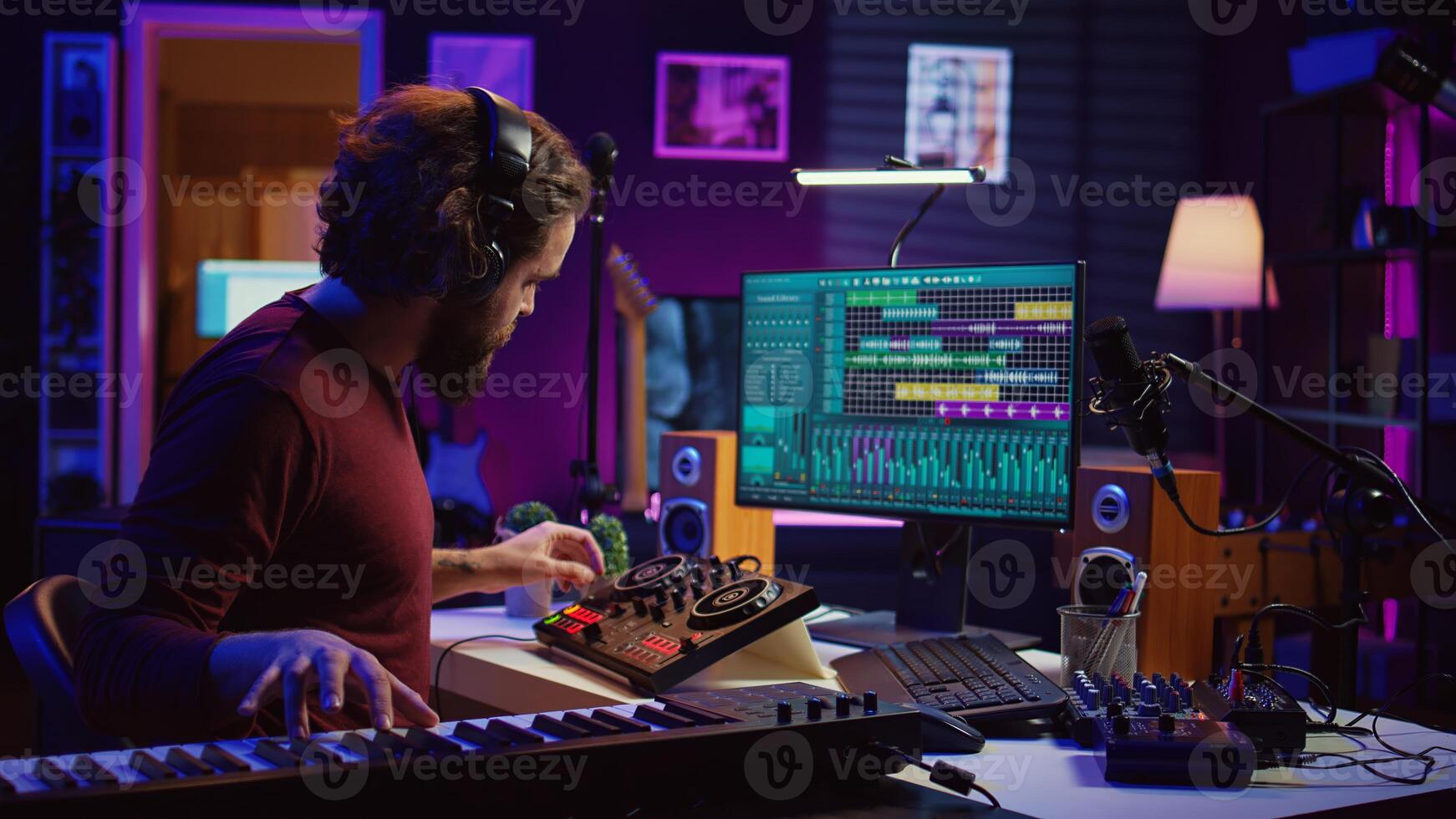 Skilled artist playing piano keyboard and recording sounds on daw software, capturing audio track instruments and vocals. Producer creating songs with mixing console in post production. Camera B. photo